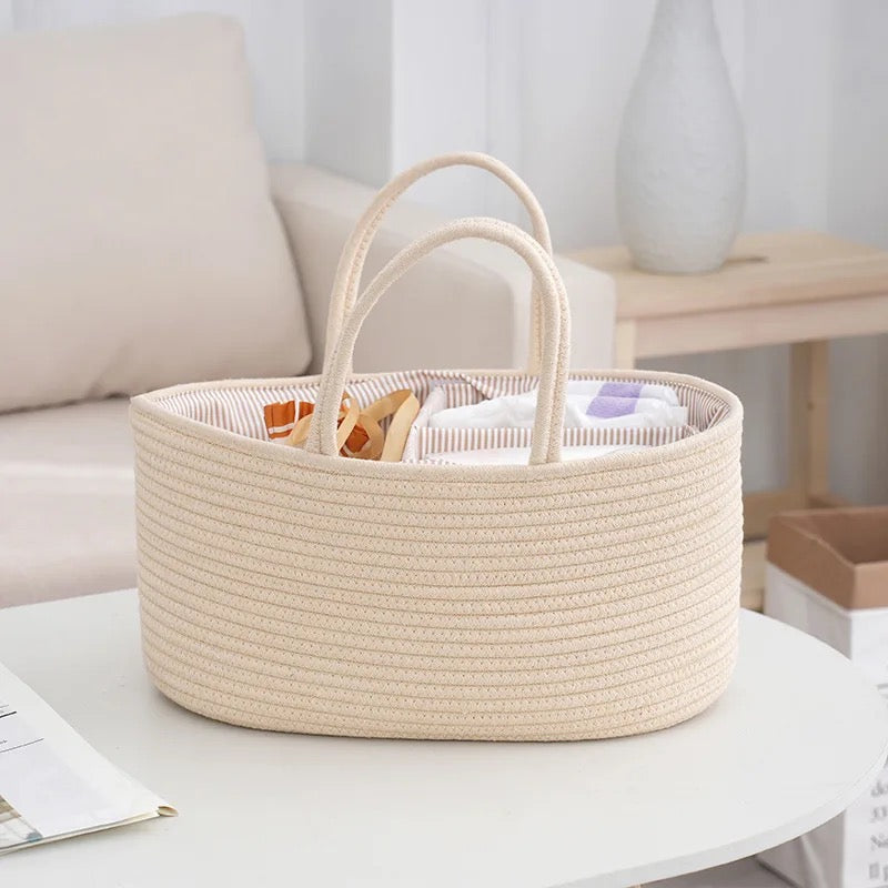 Lifestyle image of cream nappy caddy basket, perfect for keeping baby essentials organised